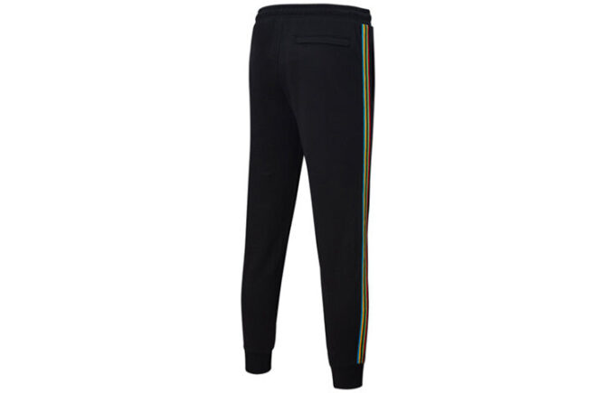 Pantalones deportivos Unity de Tailored For Sport «Negro Naranja»
